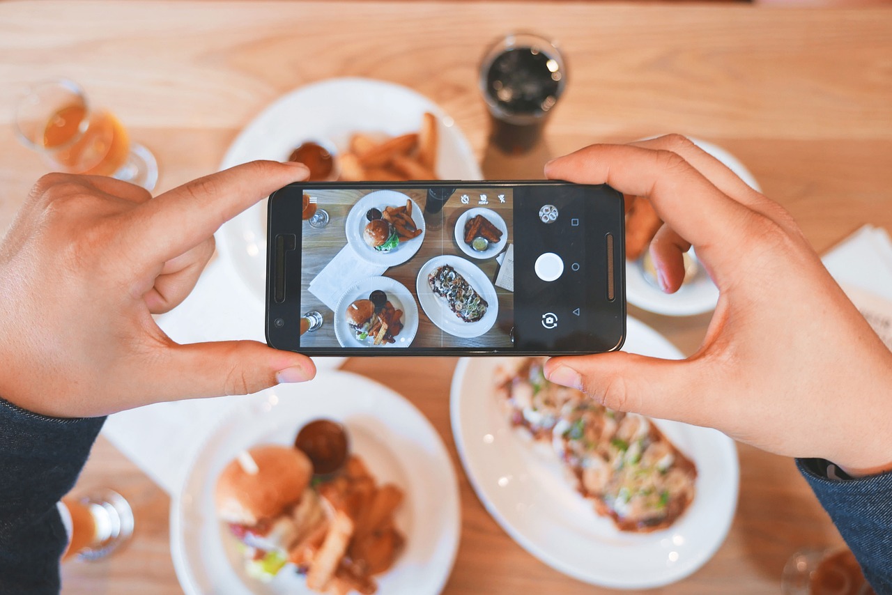 Imagen de un teléfono móvil sacando una foto a comida