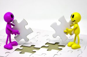 Dibujo simbólico de 2 personas con dos piezas de puzzle